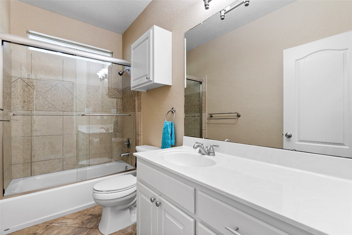 230 Cedar Hills Drive Elgin, TX 78621 - Photo 19 of 40 a bathroom with a sink a toilet and shower