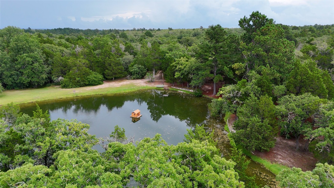 230 Cedar Hills Drive Elgin, TX 78621 - Photo 30 of 40 a view of a lake with a yard