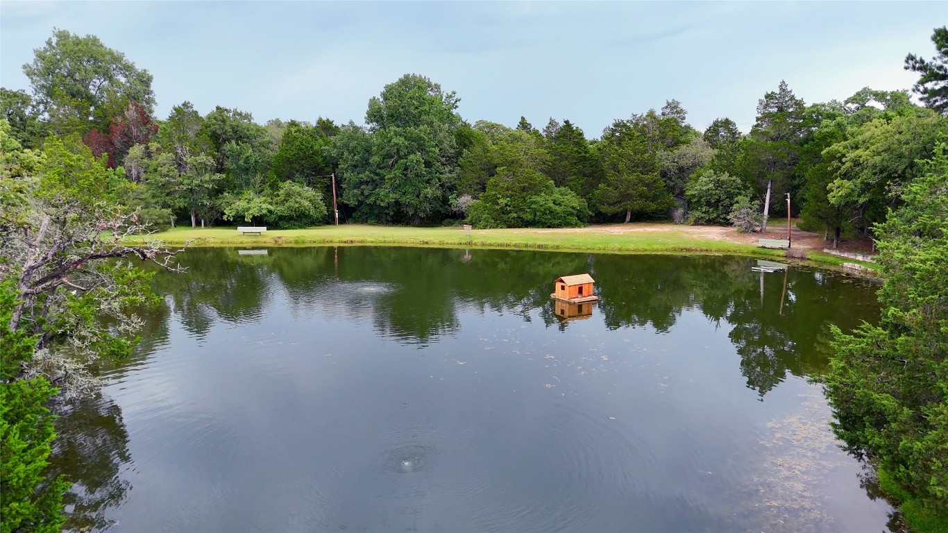 230 Cedar Hills Drive Elgin, TX 78621 - Photo 35 of 40 a view of a lake with a yard and large trees