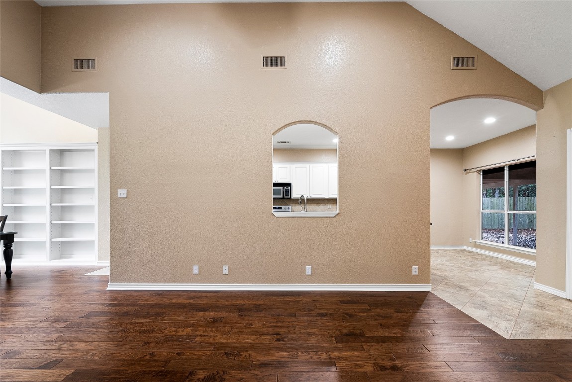 230 Cedar Hills Drive Elgin, TX 78621 - Photo 7 of 40 an empty room with wooden floor and windows