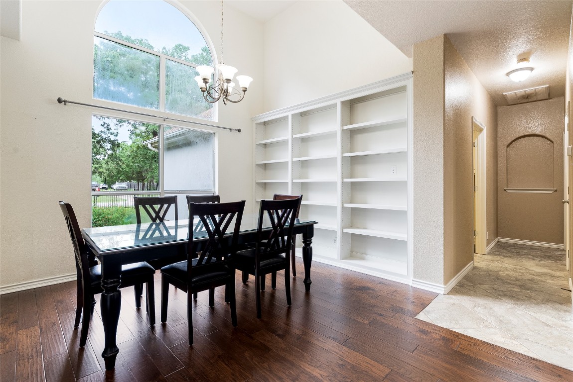 230 Cedar Hills Drive Elgin, TX 78621 - Photo 10 of 40 a view of a dining room with furniture a chandelier and wooden floor