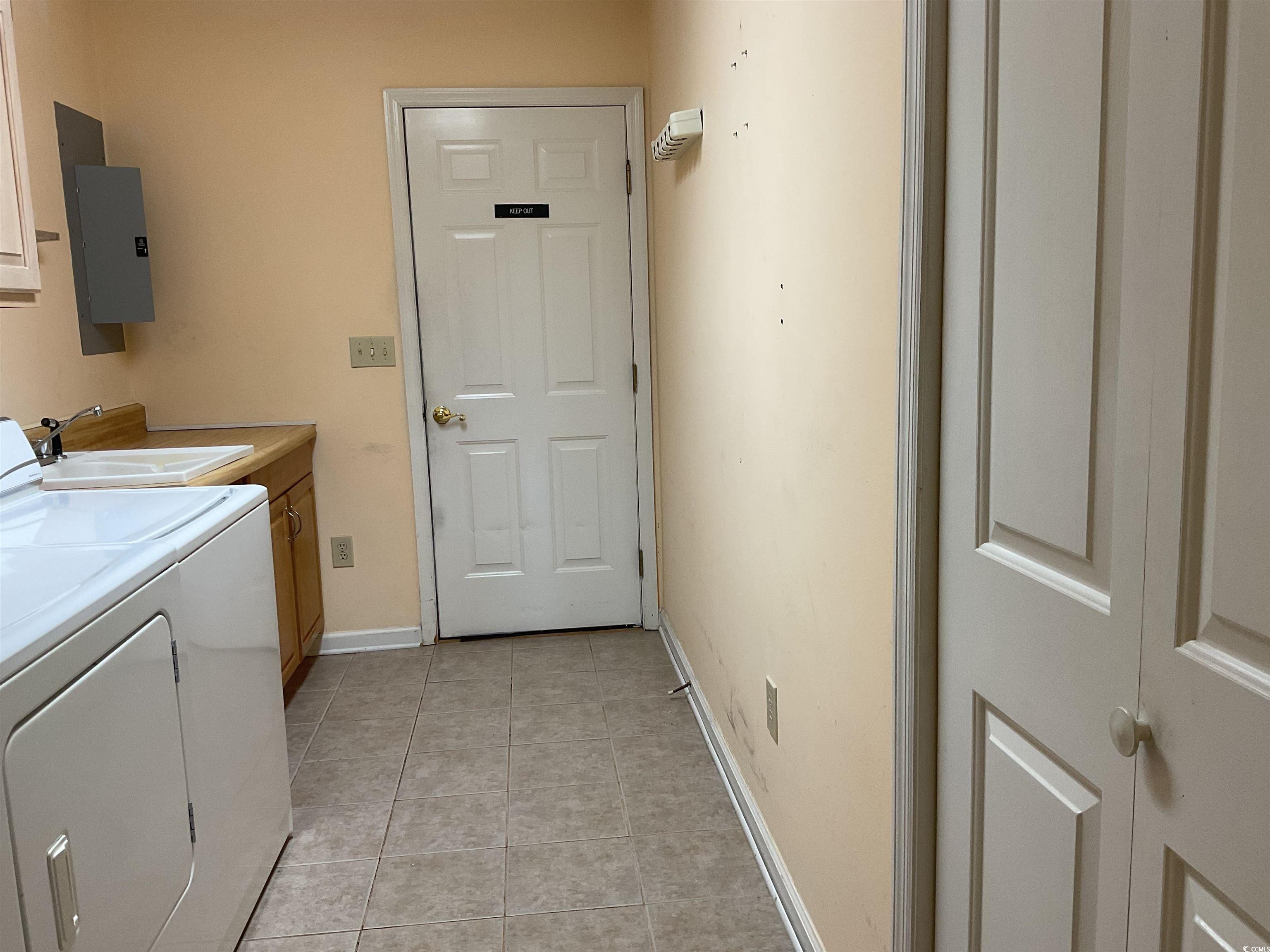 617 Waccamaw River Road Myrtle Beach, SC 29588 - Photo 14 of 17 Laundry area featuring cabinet space, washer and c