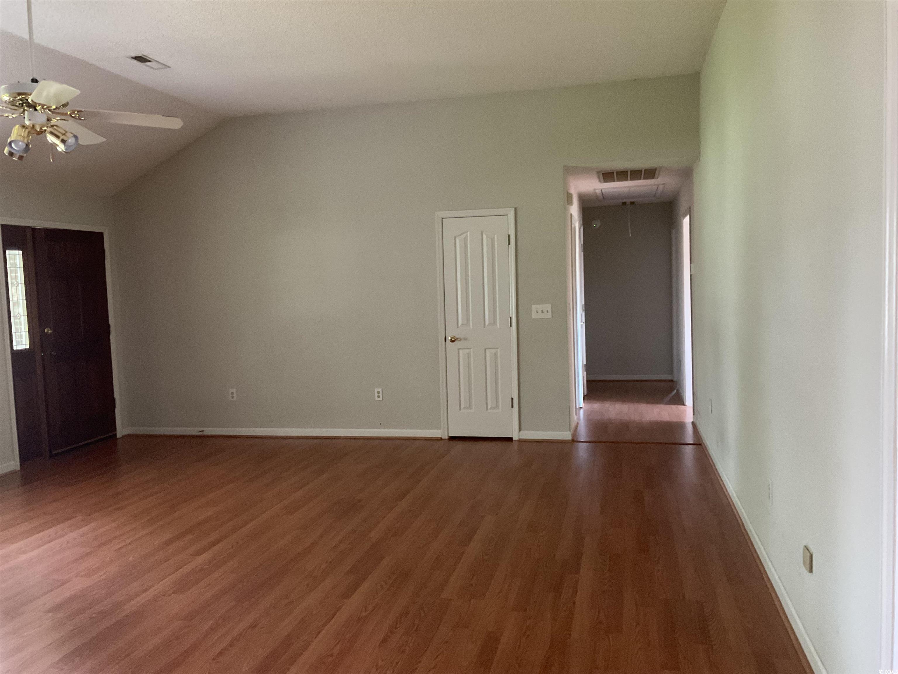 617 Waccamaw River Road Myrtle Beach, SC 29588 - Photo 4 of 17 Unfurnished living room featuring wood finished fl