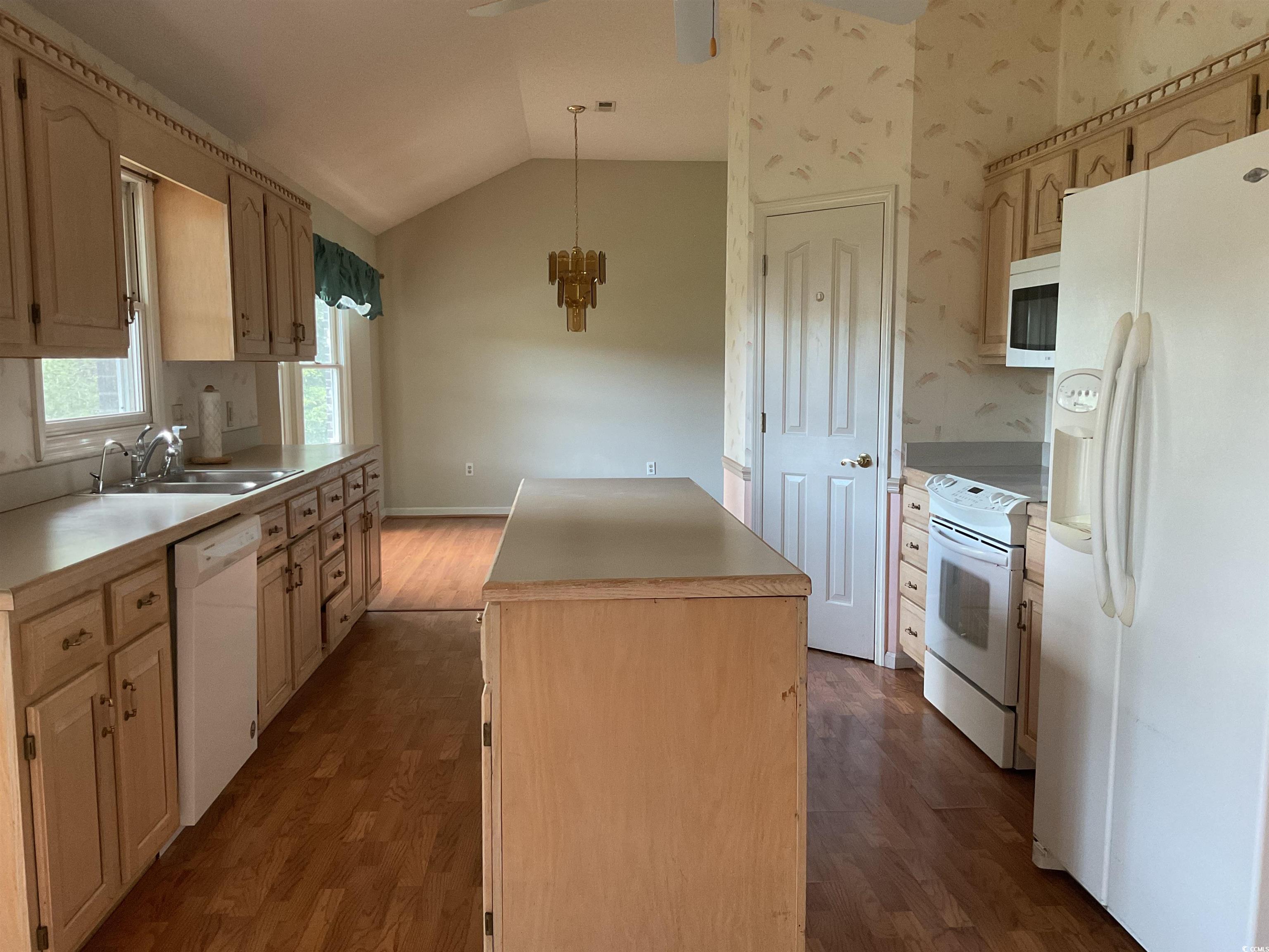 617 Waccamaw River Road Myrtle Beach, SC 29588 - Photo 6 of 17 Kitchen featuring white appliances, a center islan