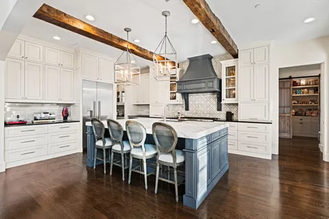 a kitchen with appliances cabinets and wooden floor