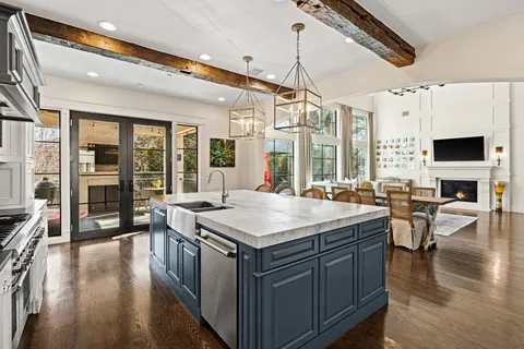 a kitchen with a stove and a chandelier