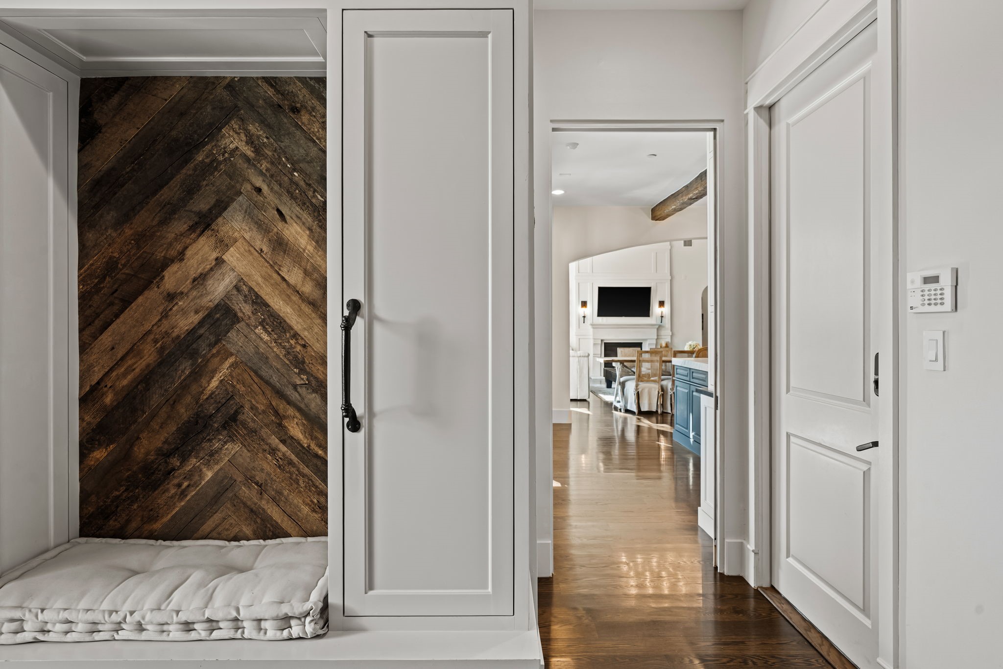 8307 Maple Court Bellaire, TX 77401 - Photo 16 of 30 a view of a hallway with wooden floor and a living room