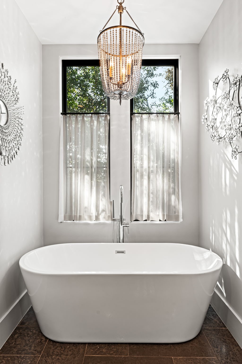8307 Maple Court Bellaire, TX 77401 - Photo 19 of 30 a white bath tub sitting in a bathroom next to a window