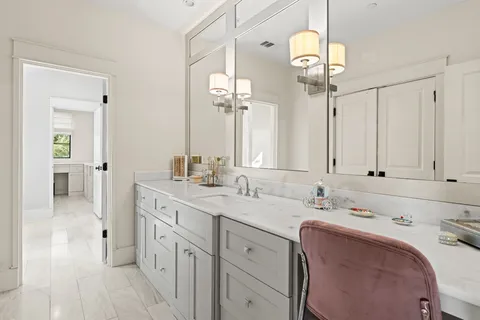 a spacious bathroom with a double vanity sink and a mirror
