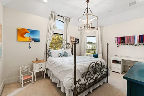 a bedroom with a bed dresser and window