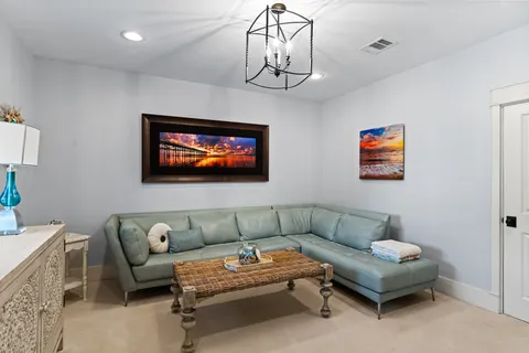 a living room with furniture a couch and a flat screen tv
