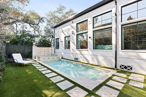 a view of a house with pool and sitting area