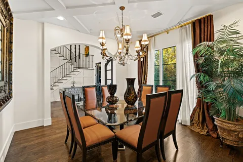 a view of a dining room with furniture and a chandelier