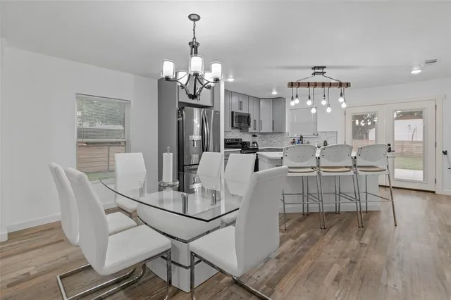 a view of a dining room with furniture and chandelier