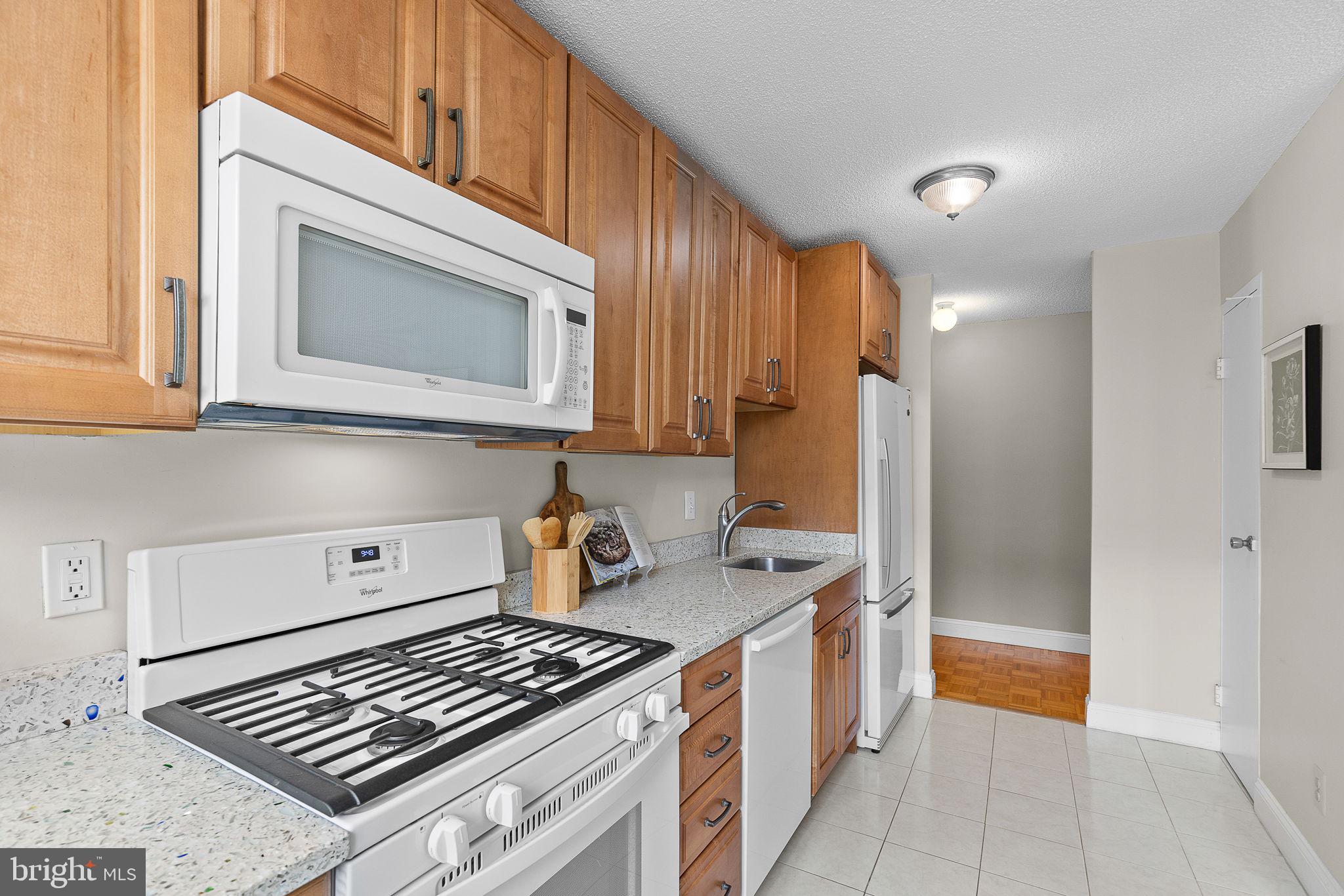 1301 South Arlington Ridge Road, Unit 208 Arlington, VA 22202 - Photo 14 of 23 a kitchen with stove and cabinets