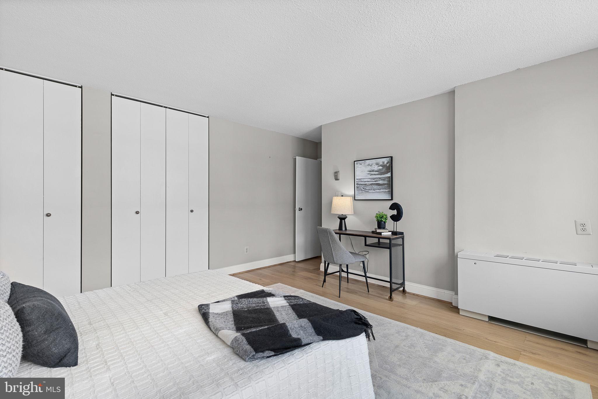 1301 South Arlington Ridge Road, Unit 208 Arlington, VA 22202 - Photo 19 of 23 a bedroom with a bed and a chair