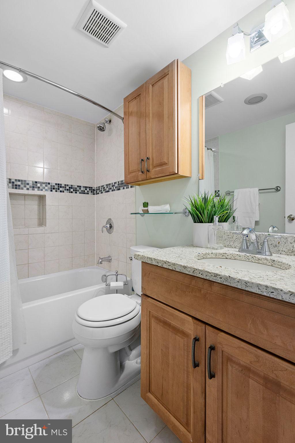 1301 South Arlington Ridge Road, Unit 208 Arlington, VA 22202 - Photo 21 of 23 a bathroom with a sink a toilet and shower