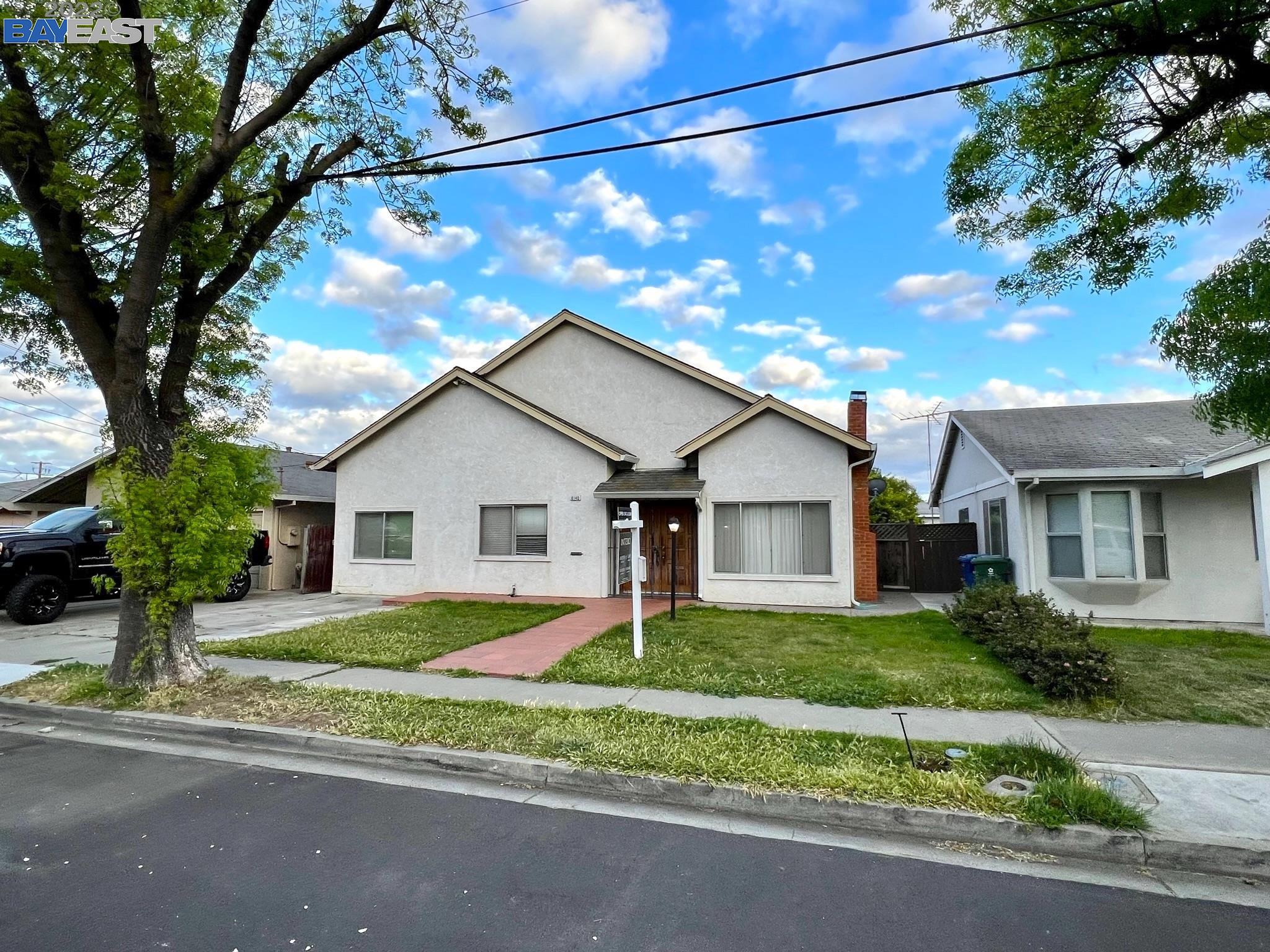 a house that has a tree in front of it
