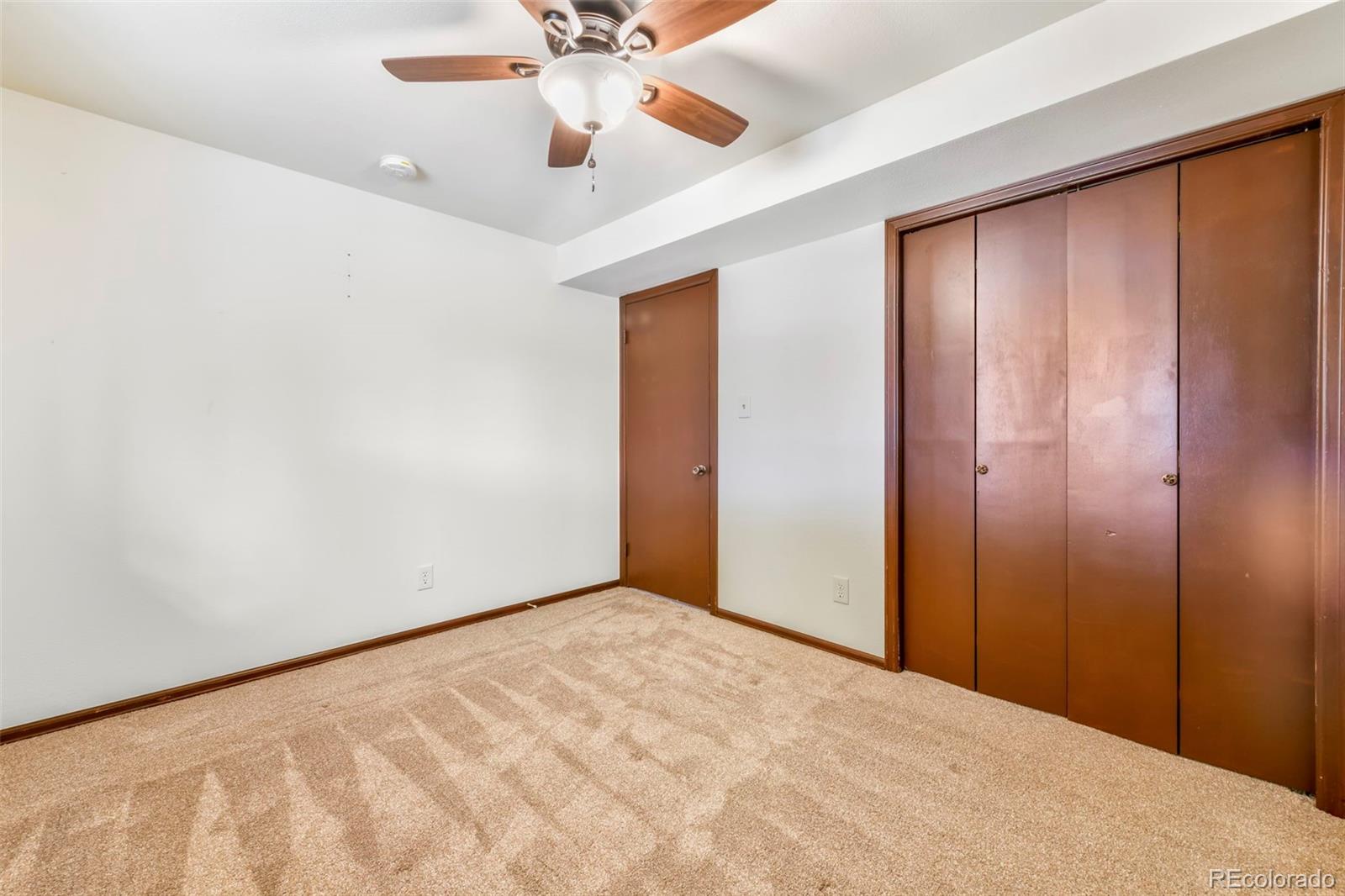 463 Washington Street Monument, CO 80132 - Photo 26 of 50 an empty room with chandelier fan and closet area