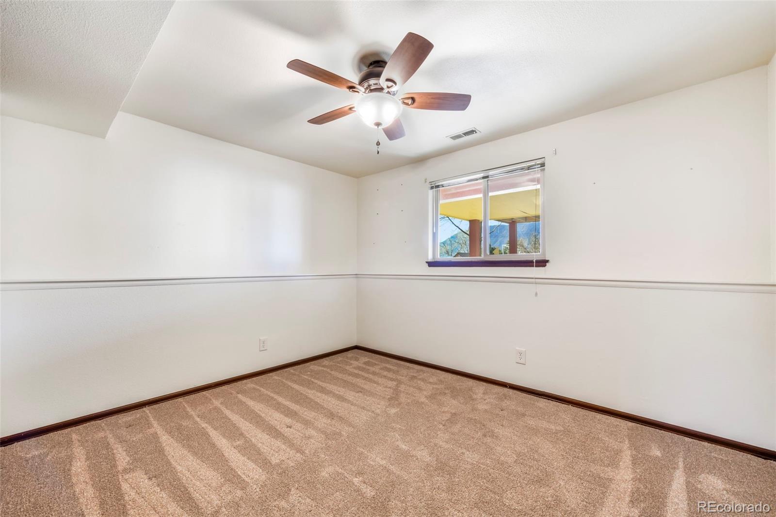 463 Washington Street Monument, CO 80132 - Photo 27 of 50 an empty room with windows and ceiling fan