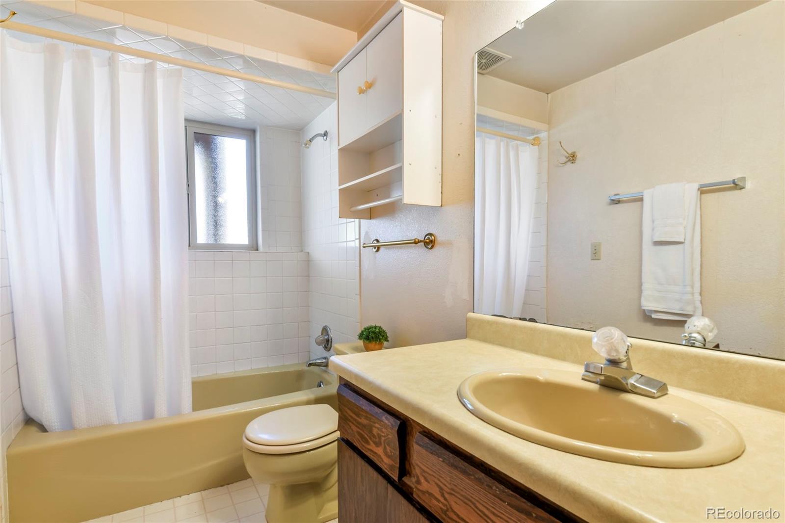 463 Washington Street Monument, CO 80132 - Photo 28 of 50 a bathroom with a sink a toilet and tub