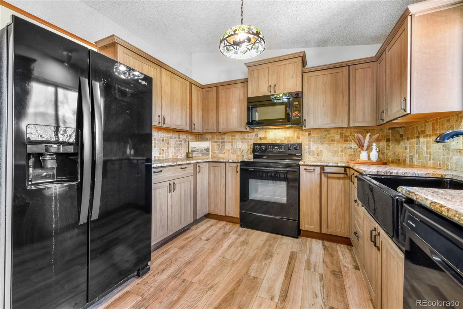 463 Washington Street Monument, CO 80132 - Photo 8 of 50 a kitchen with a sink stainless steel appliances and cabinets
