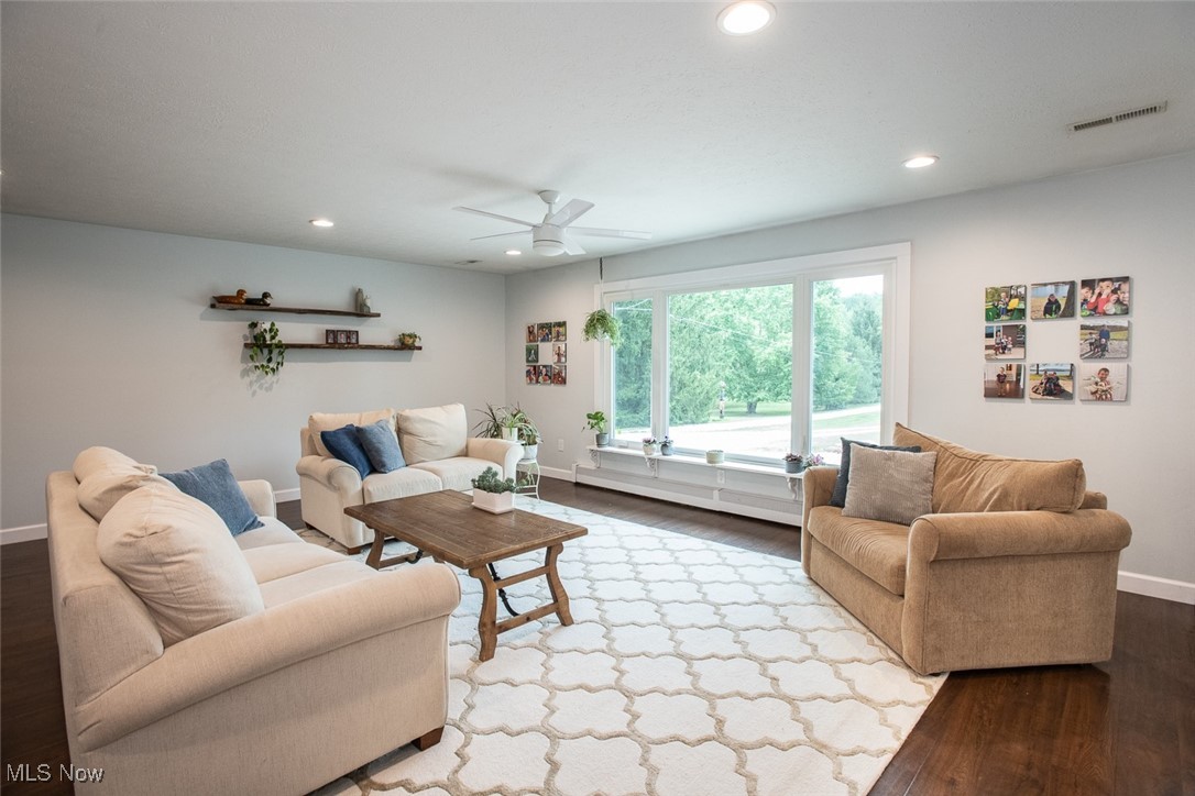 3434 Hamlin Road Medina, OH 44256 - Photo 7 of 37 Living room with a baseboard heating unit, hardwood / wood-style flooring, and ceiling fan