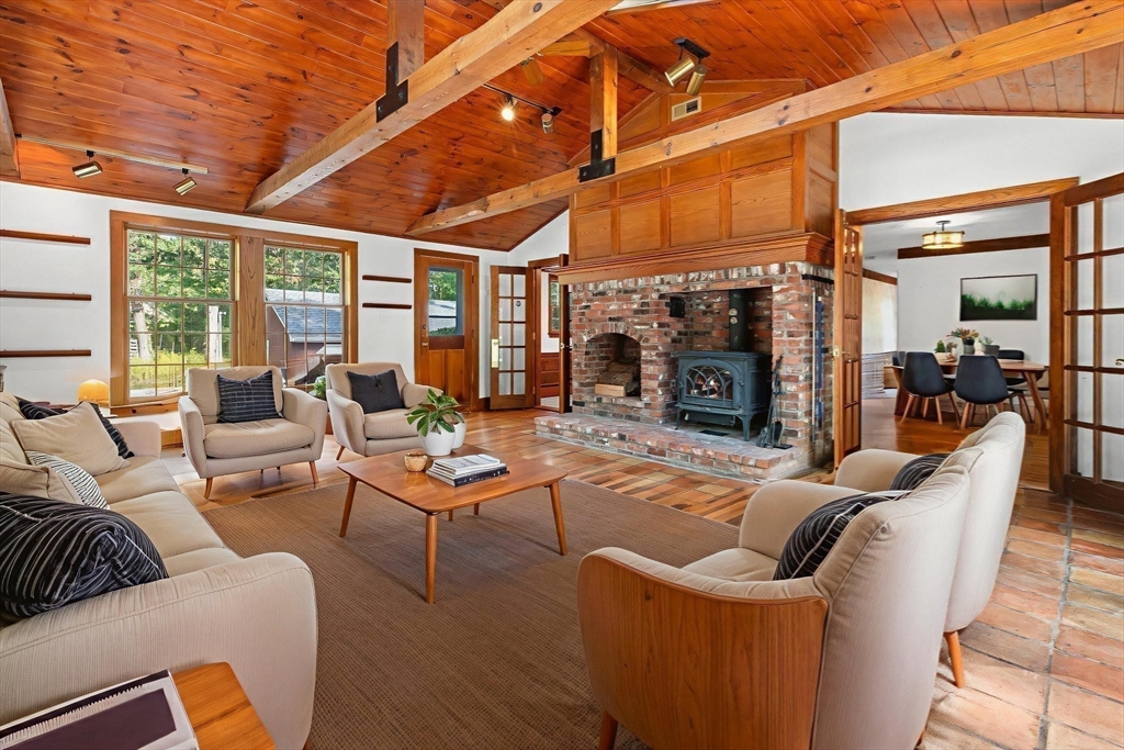 182 Georgetown Road Boxford, MA 01921 - Photo 11 of 41 a living room with furniture a fireplace and a table