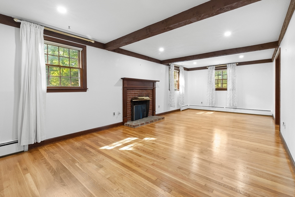 182 Georgetown Road Boxford, MA 01921 - Photo 5 of 41 an empty room with windows and fireplace