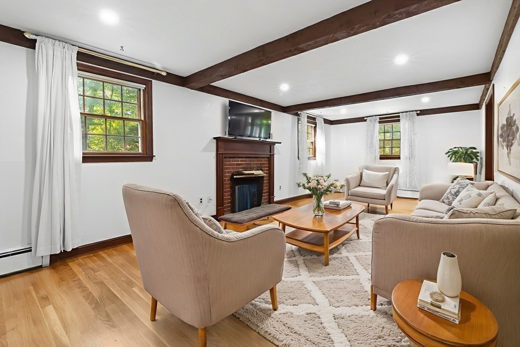 182 Georgetown Road Boxford, MA 01921 - Photo 6 of 41 a living room with furniture a fireplace and a floor to ceiling window