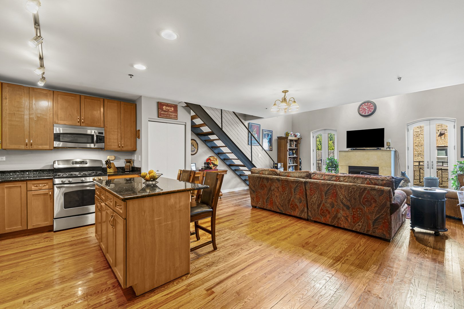 331 South Ridgeland Avenue, Unit B Oak Park, IL 60302 - Photo 4 of 20 a kitchen with stainless steel appliances granite countertop a refrigerator a stove top oven a sink dishwasher and wooden cabinets with wooden floor