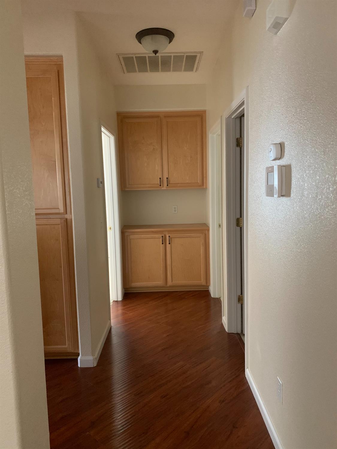 3532 Lauding Way Modesto, CA 95355 - Photo 13 of 21 a view of a hallway with wooden floor