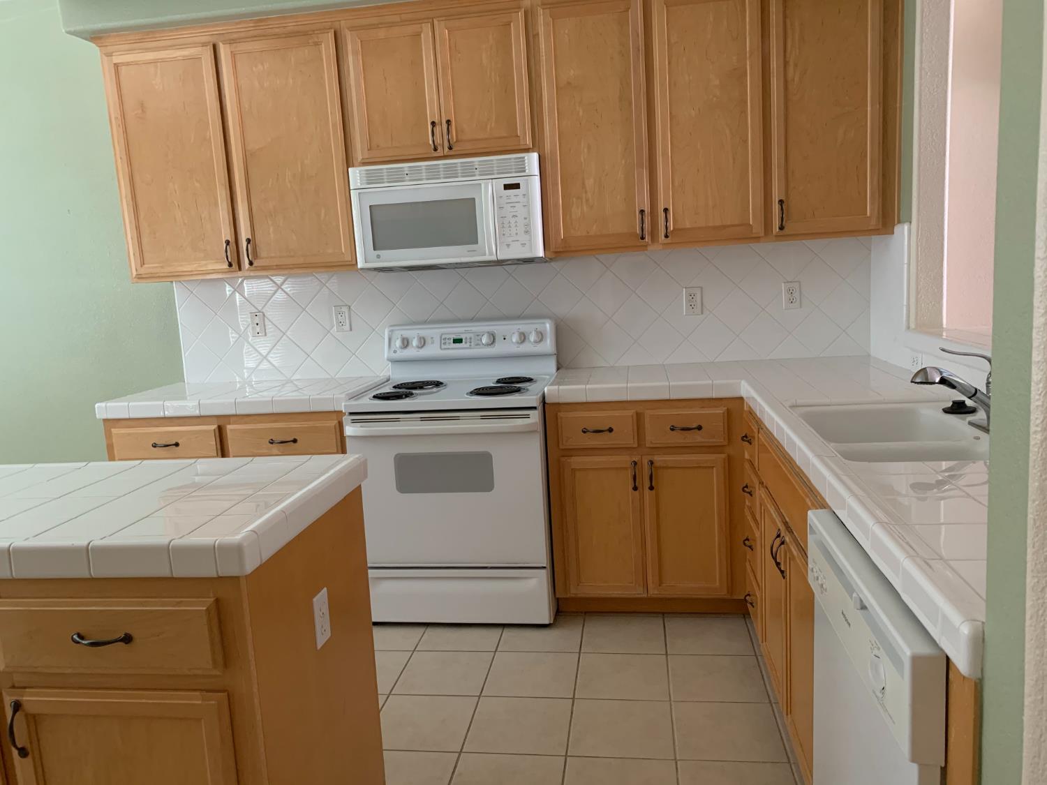 3532 Lauding Way Modesto, CA 95355 - Photo 3 of 21 a utility room with cabinets washer and dryer