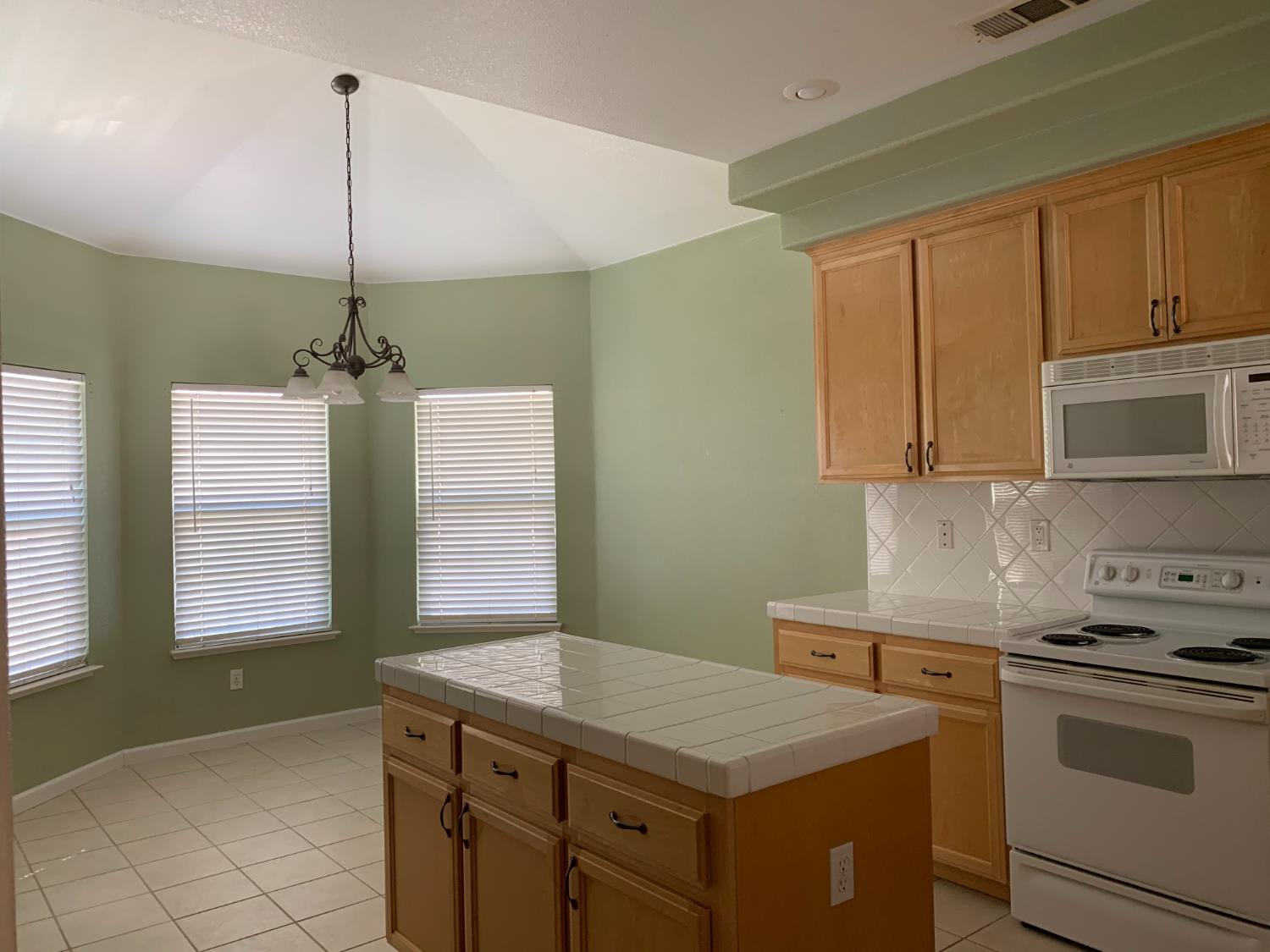 3532 Lauding Way Modesto, CA 95355 - Photo 4 of 21 a kitchen with a sink stove and microwave