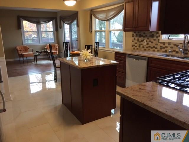 12 Sinclair Road Edison, NJ 08820 - Photo 7 of 18 a kitchen with a sink a counter top space and living room
