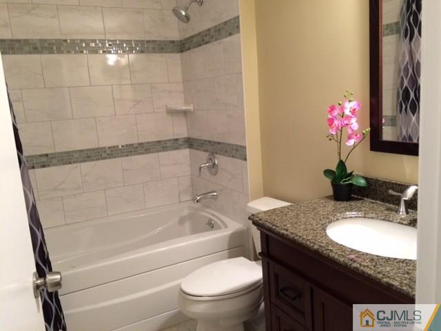 12 Sinclair Road Edison, NJ 08820 - Photo 8 of 18 a bathroom with a granite countertop sink a toilet and shower