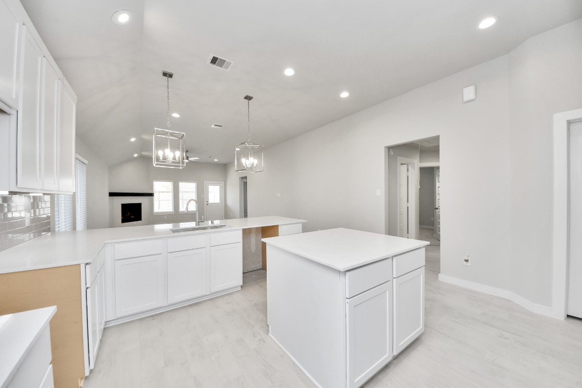 2918 Burris Park Drive Spring, TX 77373 - Photo 5 of 34 a large white kitchen with a sink and dishwasher a refrigerator with white cabinets