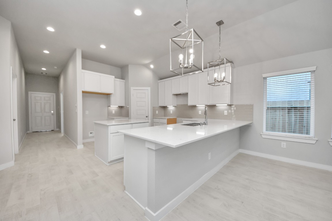 2918 Burris Park Drive Spring, TX 77373 - Photo 8 of 34 a large kitchen with kitchen island a sink a center island stainless steel appliances and a window
