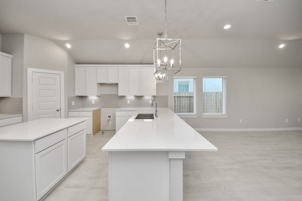 2918 Burris Park Drive Spring, TX 77373 - Photo 9 of 34 a large kitchen with kitchen island a sink appliances and cabinets