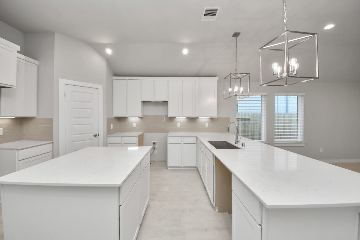 2918 Burris Park Drive Spring, TX 77373 - Photo 10 of 34 a large kitchen with kitchen island a sink stainless steel appliances and cabinets