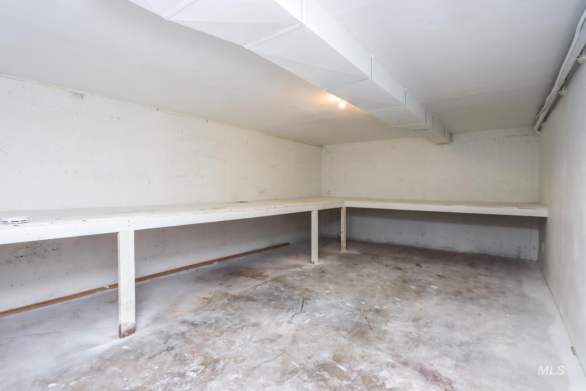 801 Thompson Avenue Nyssa, OR 97913 - Photo 34 of 46 Utility space featuring concrete flooring, built-in shelving, exposed ductwork, and overhead lighting