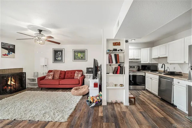 a living room with furniture fireplace and flat screen tv