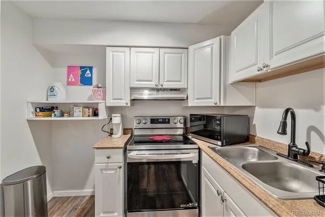 a kitchen with stainless steel appliances granite countertop a sink stove and cabinets