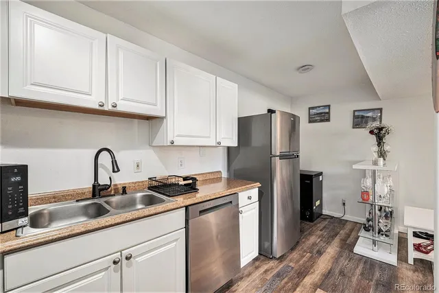 a kitchen with stainless steel appliances granite countertop a refrigerator sink and cabinets