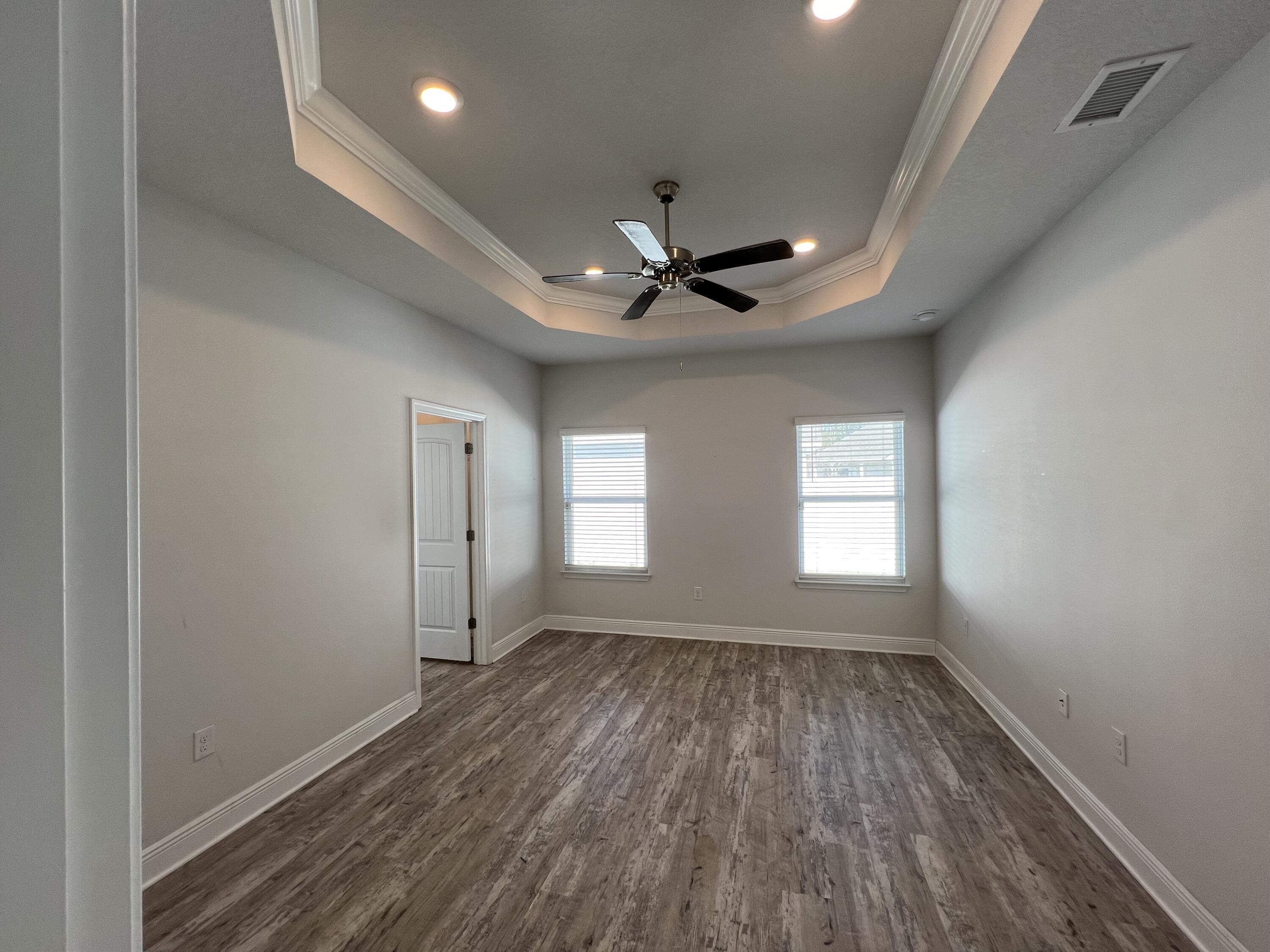 113 Southern Pnes Road Santa Rosa Beach, FL 32459 - Photo 8 of 17 a view of empty room with wooden floor and fan