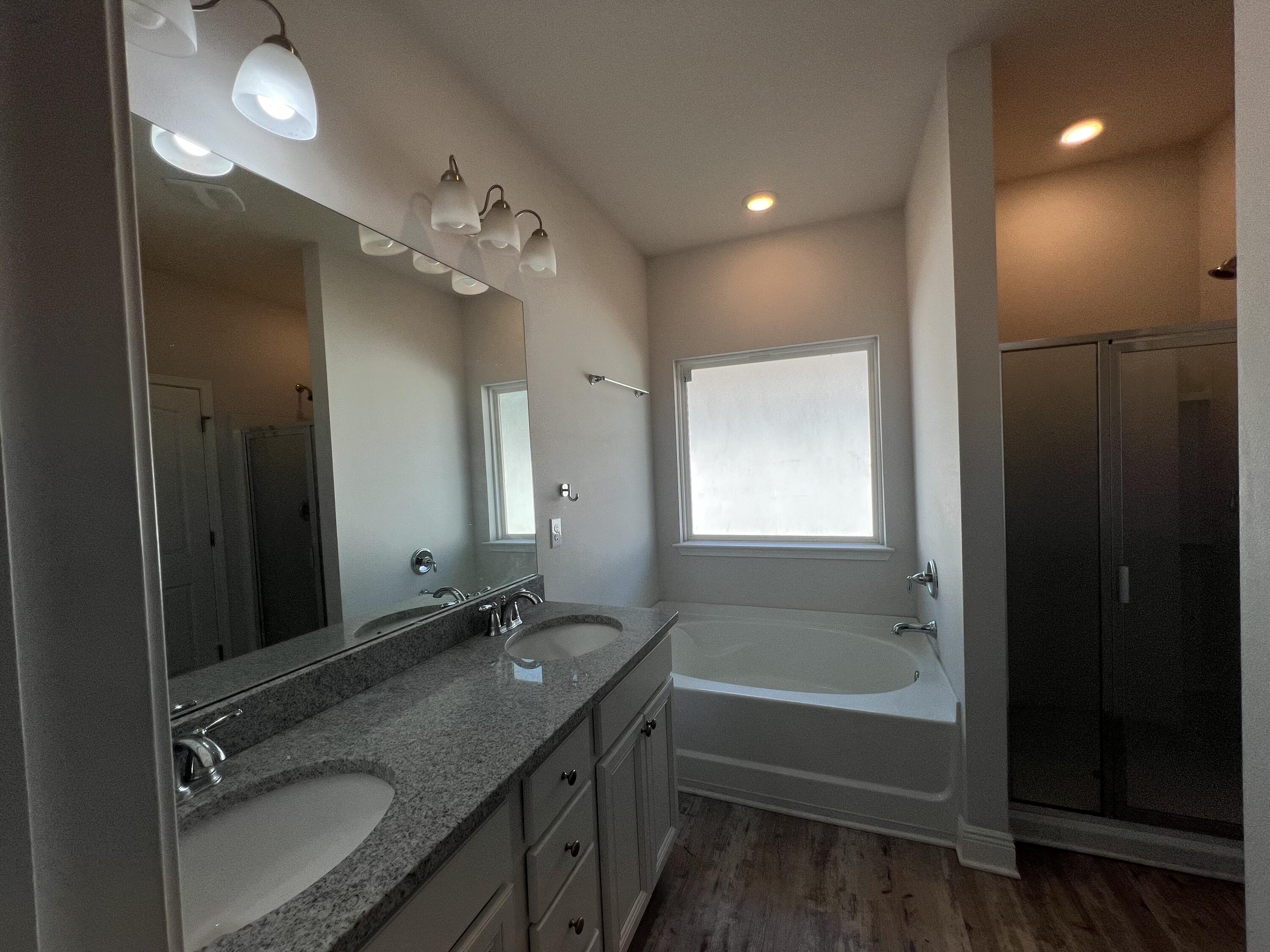 113 Southern Pnes Road Santa Rosa Beach, FL 32459 - Photo 10 of 17 a bathroom with a granite countertop sink a toilet a mirror and shower