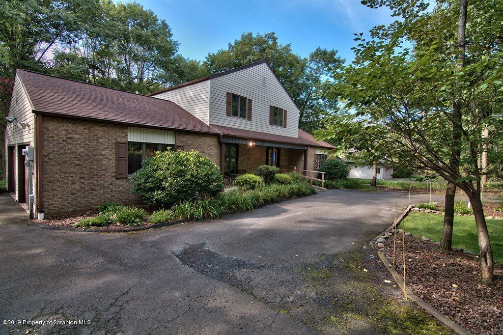 1000 Forest Road Lake Ariel, PA 18436 - Photo 45 of 49 a front view of a house with a yard and garage