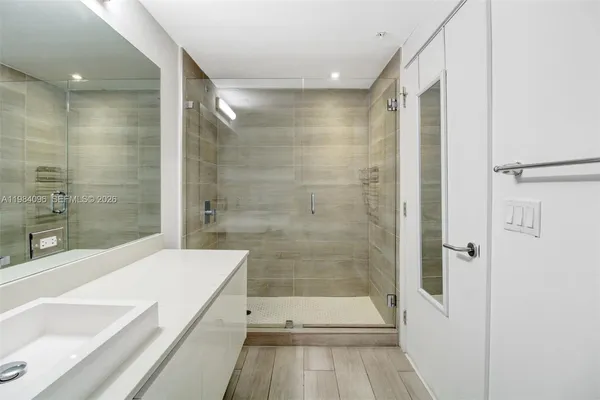 a bathroom with a bathtub and a shower