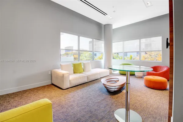 a living room with furniture and a large window