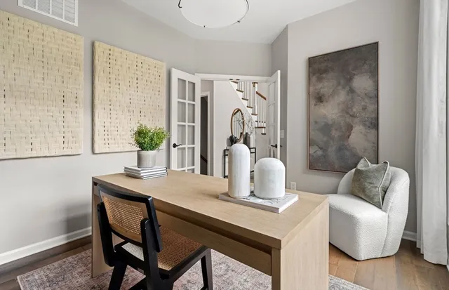 a dining room with furniture and wooden floor